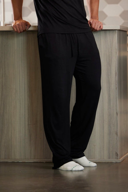 Spun Bamboo men's lounge pants in Black, front view on a standing model; shirt and socks not included.
