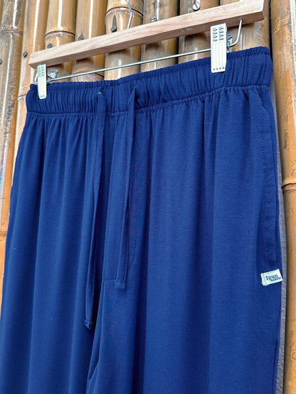 Close-up of Navy Blue Spun Bamboo lounge pants showing the elastic waistband, drawstring and side label.