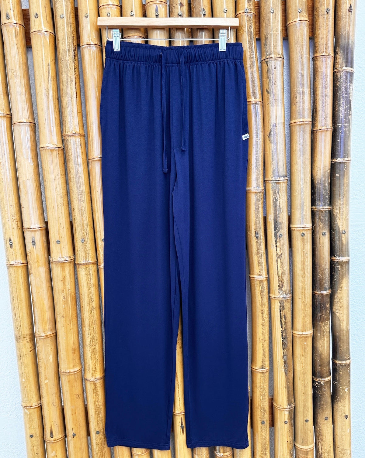 Spun Bamboo men's lounge pants in Navy Blue on a hanger, full front view showing waistband and drawstring.