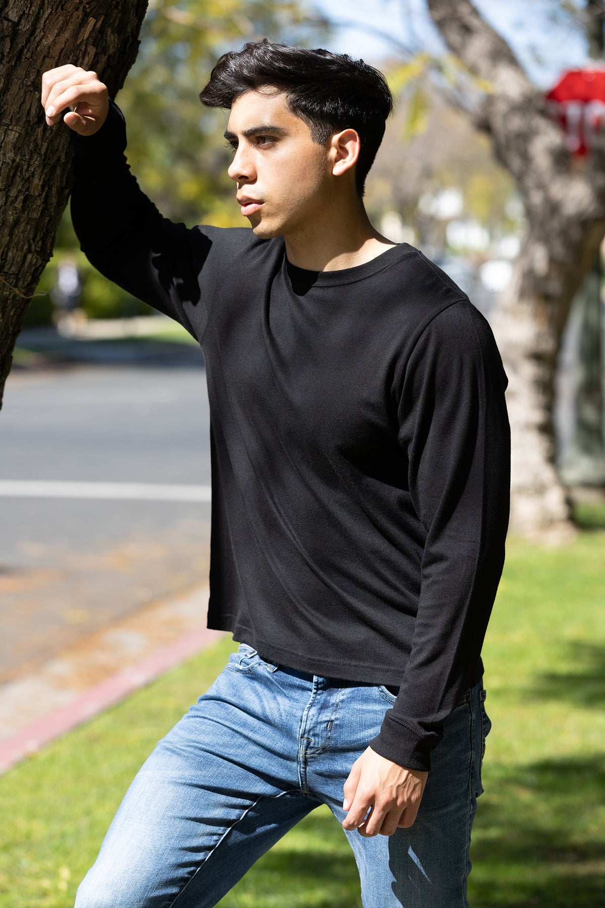 Spun Bamboo long-sleeve crewneck in Black, styled outdoors with jeans.