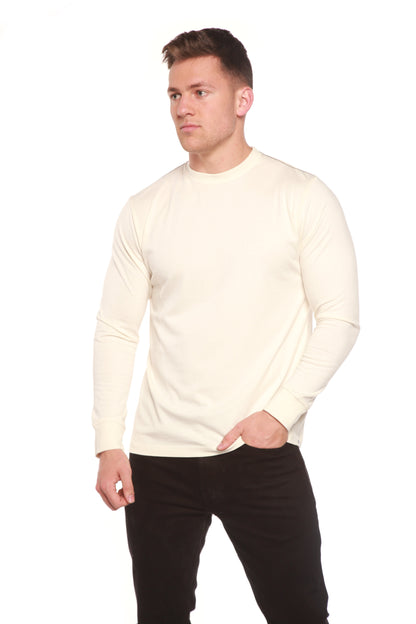 Front view of the Spun Bamboo long-sleeve crewneck in Natural, styled with black trousers.